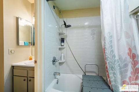 a bathroom with a shower and a sink