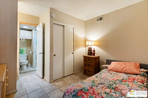 a bedroom with a bed and a mirror