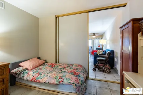 a bedroom with a bed and a mirror