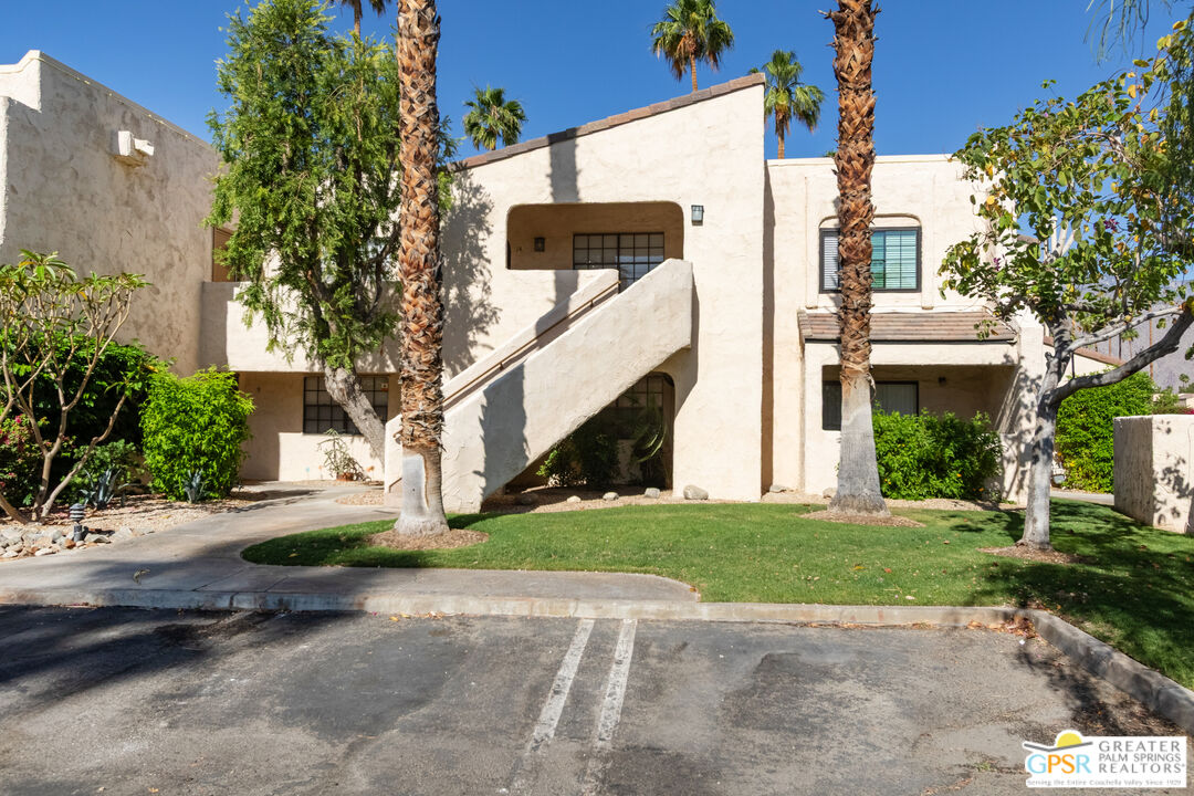 5300 East Waverly Drive, Unit C13 Palm Springs, CA 92264 - Photo 22 of 32 a view of a white house next to a yard