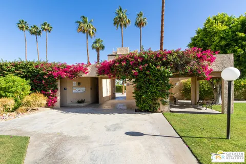 a front view of a house with a porch and a yard