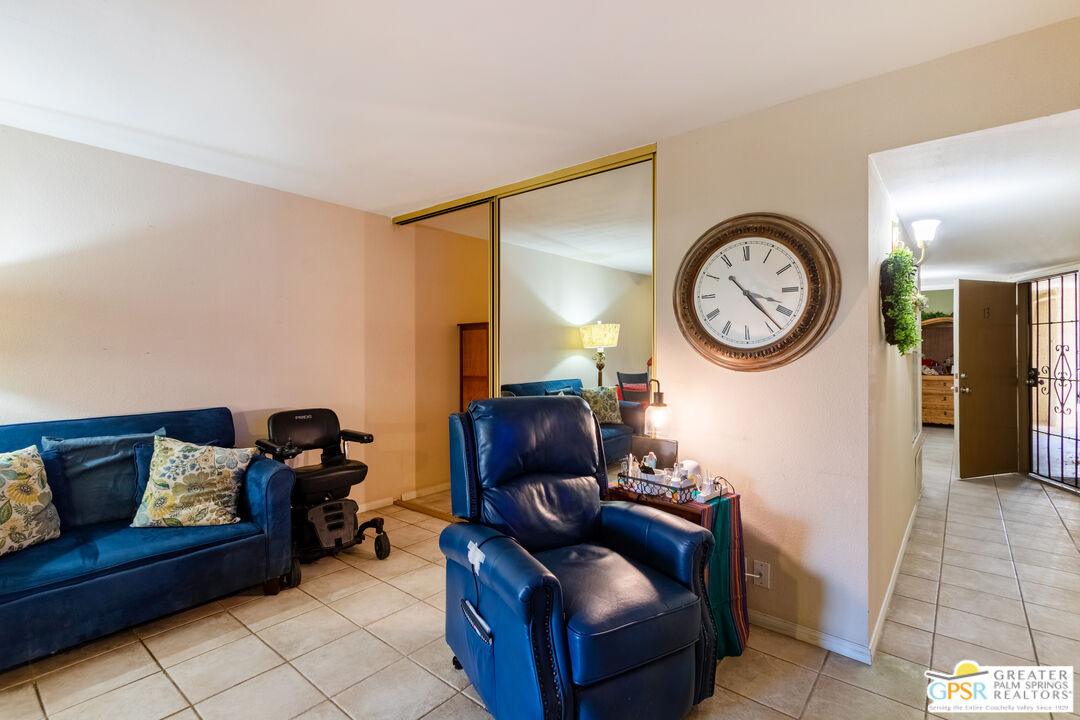 5300 East Waverly Drive, Unit C13 Palm Springs, CA 92264 - Photo 7 of 32 a living room with furniture and a mirror