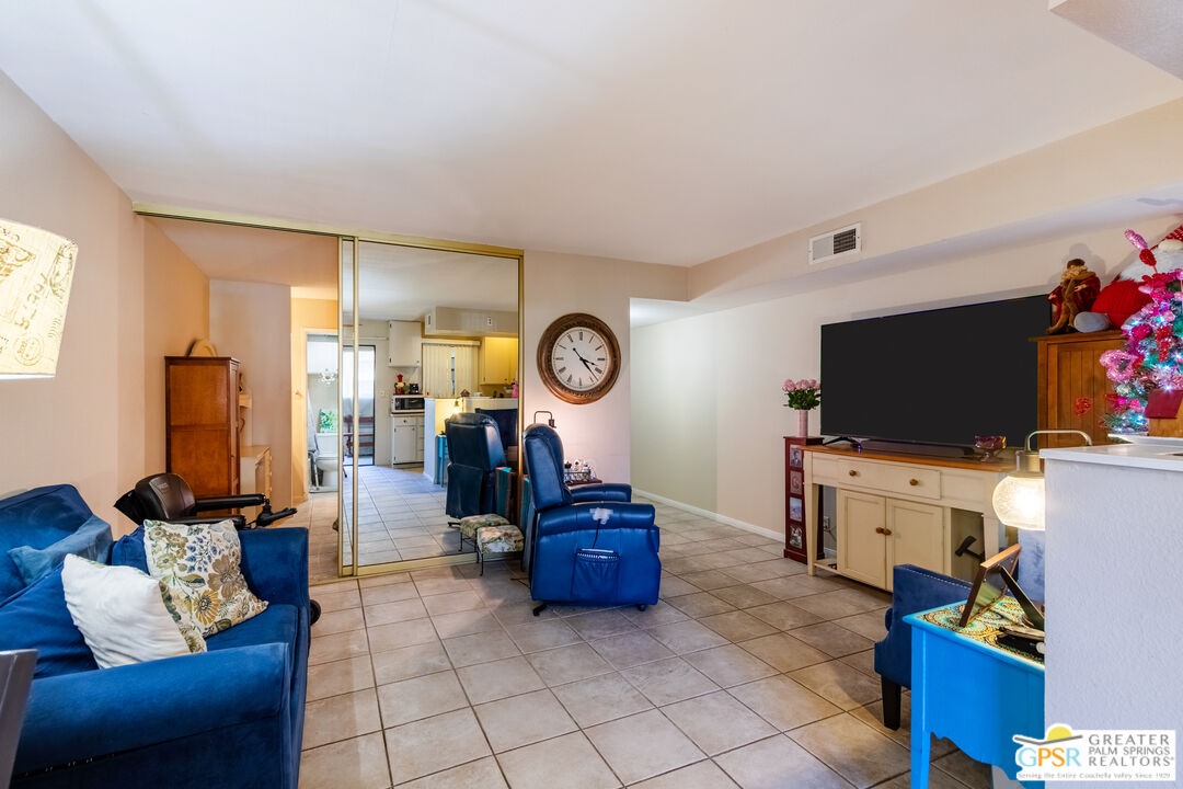 5300 East Waverly Drive, Unit C13 Palm Springs, CA 92264 - Photo 8 of 32 a living room with furniture and a flat screen tv