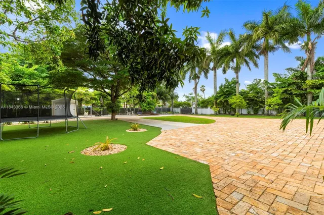 an aerial view of house with outdoor space and swimming pool