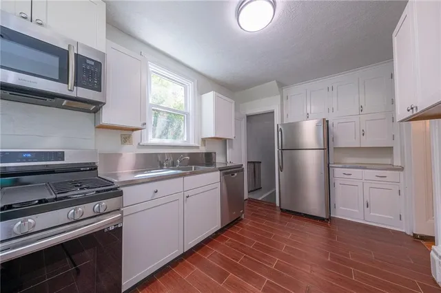 a kitchen with a refrigerator stove and sink