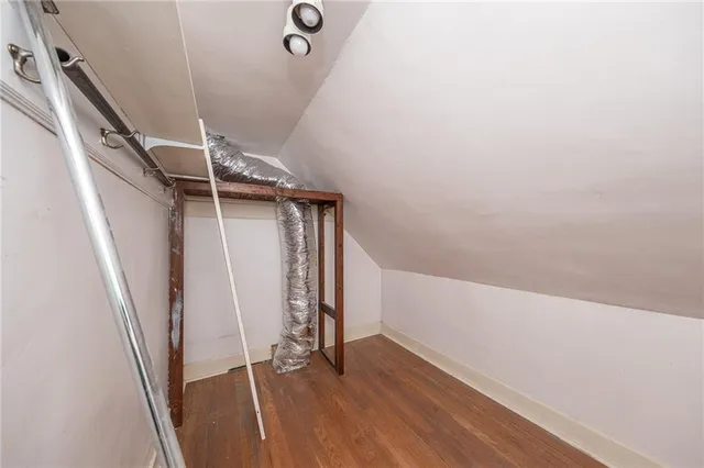 an entryway in a hall with wooden floor