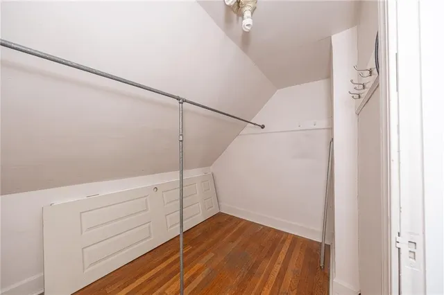 a view of walk in closet with empty racks