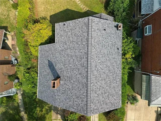 an aerial view of residential houses with outdoor space and street view