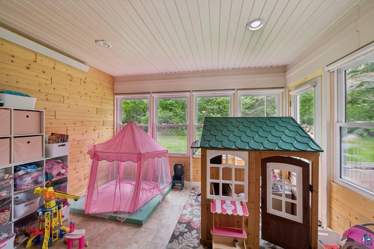 202 Prentice Heights Road Ashland, WI 54806 - Photo 15 of 28 Sunroom featuring wood-finish wall paneling, white paneled ceiling, recessed lighting, multiple windows, and light-colored flooring