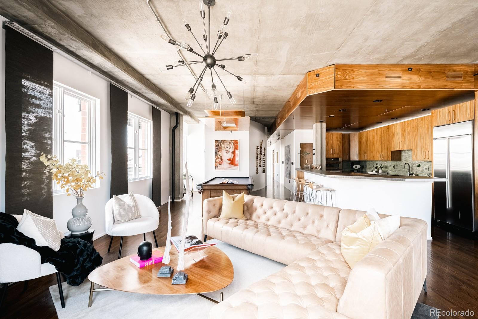 a living room with furniture and a chandelier