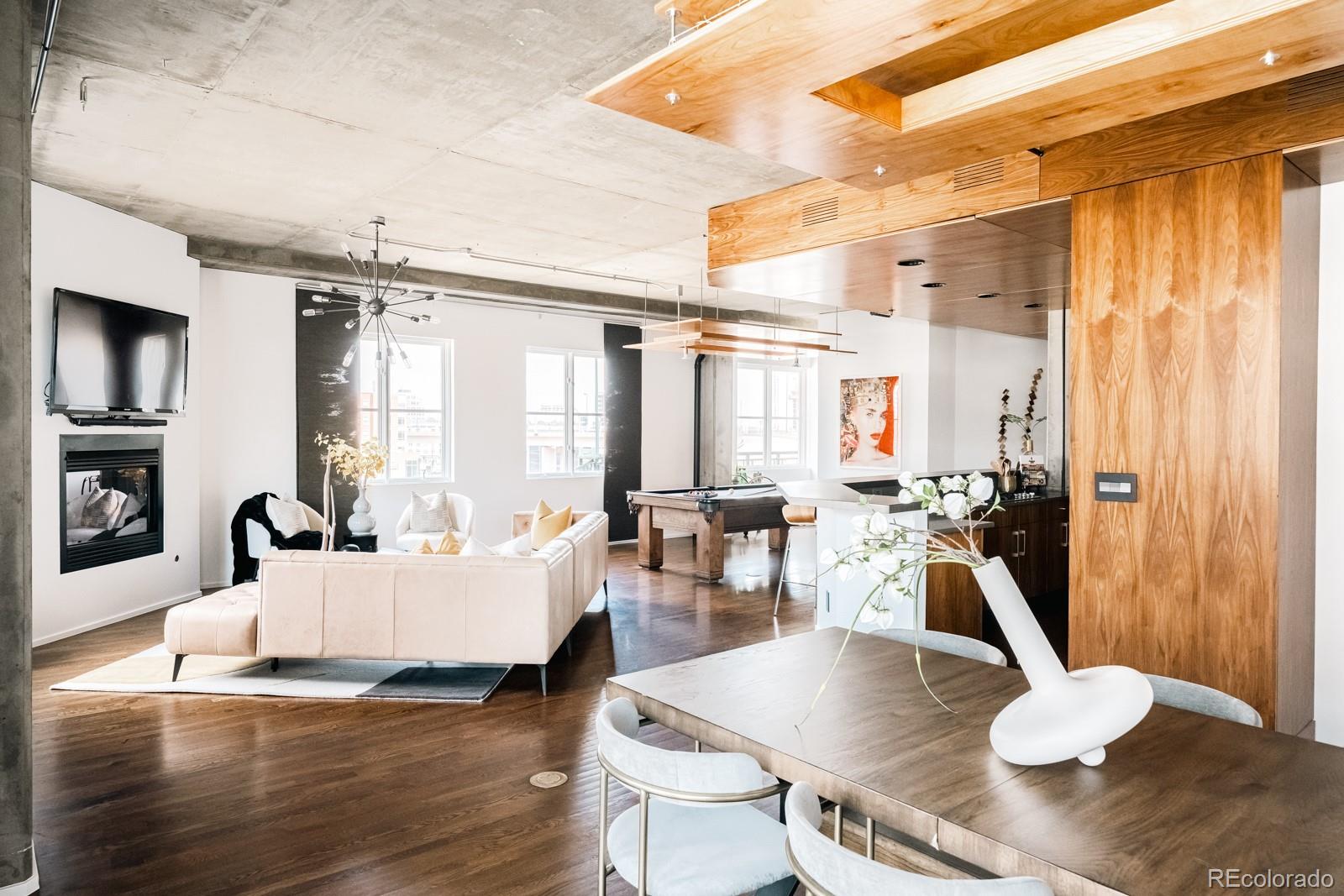 1735 19th Street, Unit 4A Denver, CO 80202 - Photo 14 of 25 a living room with furniture large window and wooden floor