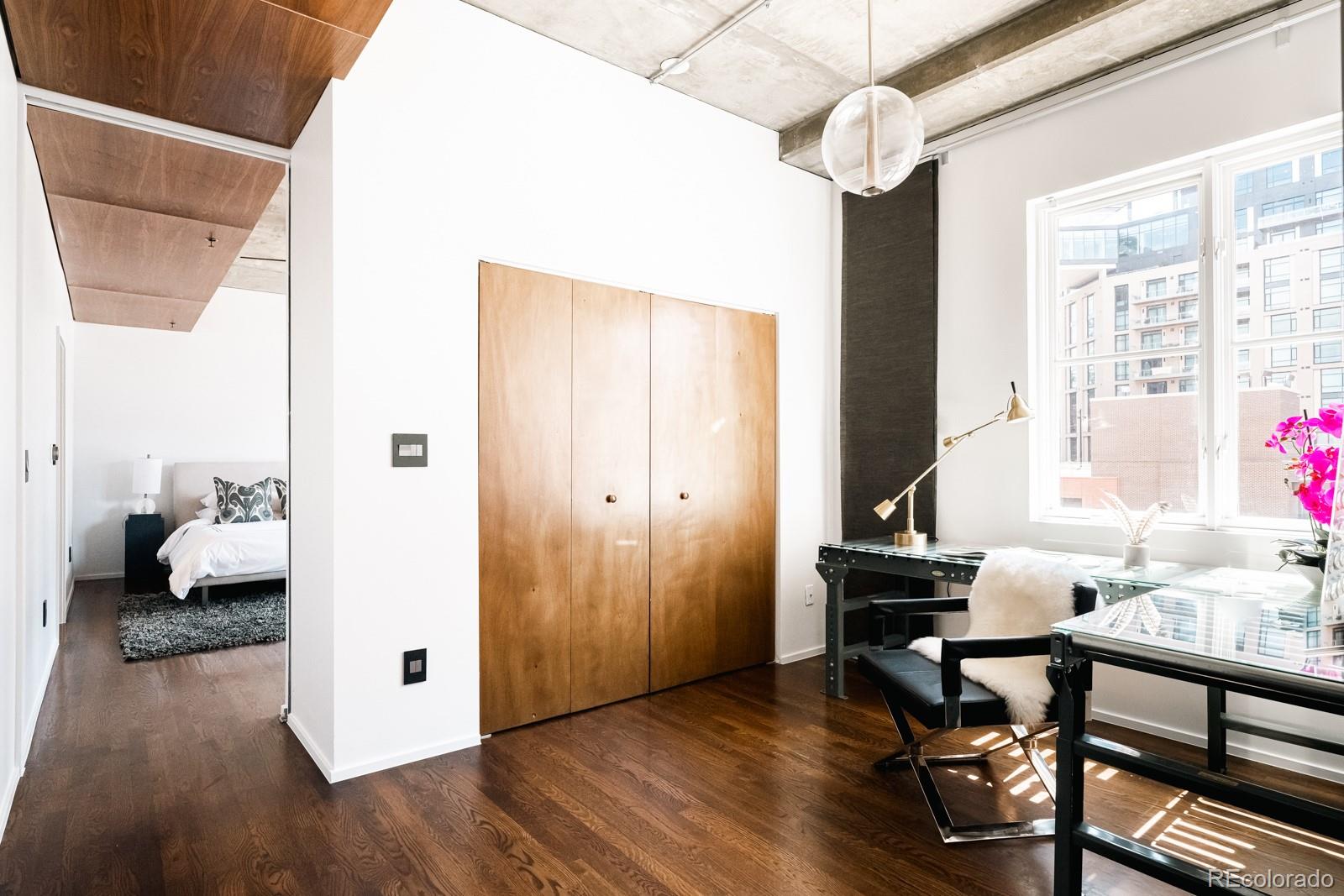 1735 19th Street, Unit 4A Denver, CO 80202 - Photo 17 of 25 a workspace with furniture window and wooden floor