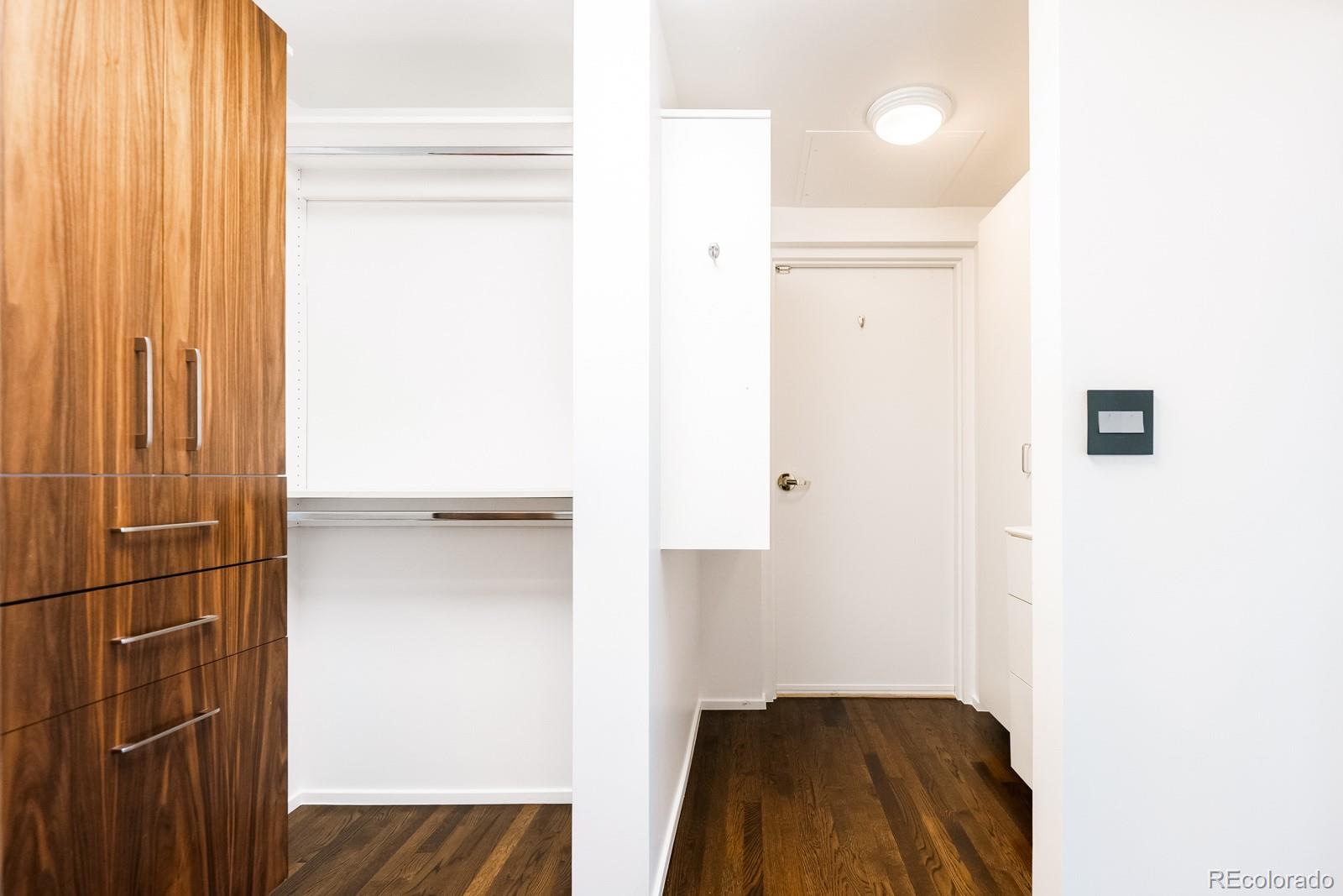 1735 19th Street, Unit 4A Denver, CO 80202 - Photo 22 of 25 a hallway with sliding door and wooden floor
