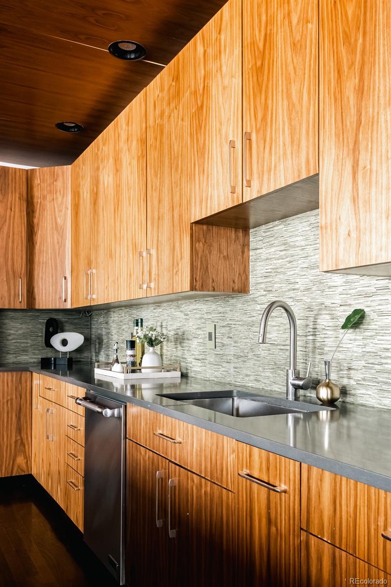 1735 19th Street, Unit 4A Denver, CO 80202 - Photo 10 of 25 a kitchen with stainless steel appliances a sink a stove and cabinets