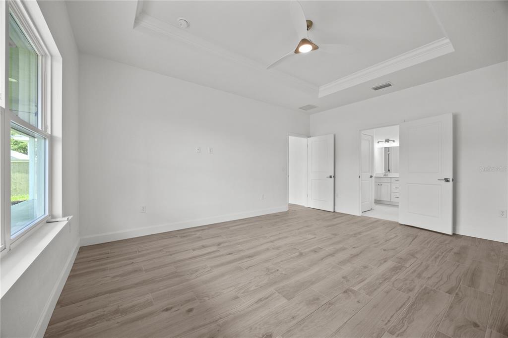1018 Southwest 67th Drive Gainesville, FL 32607 - Photo 14 of 29 wooden floor in an empty room with a window