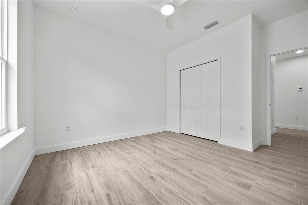 1018 Southwest 67th Drive Gainesville, FL 32607 - Photo 23 of 29 an empty room with wooden floor