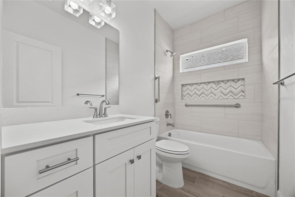 1018 Southwest 67th Drive Gainesville, FL 32607 - Photo 24 of 29 a bathroom with a sink a toilet and shower
