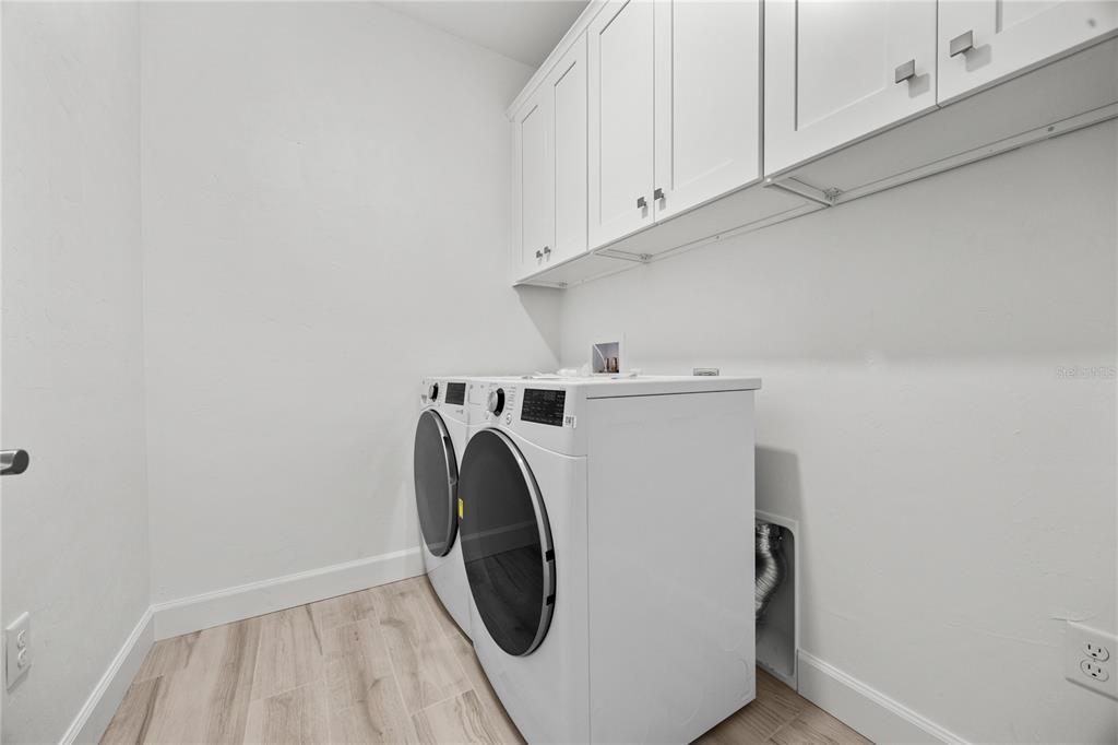 1018 Southwest 67th Drive Gainesville, FL 32607 - Photo 25 of 29 a utility room with dryer and washer