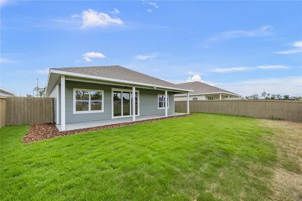 a view of a house with a backyard