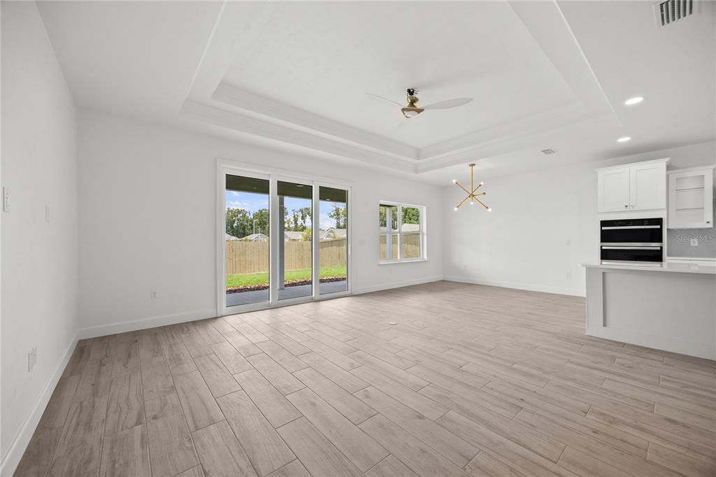 1018 Southwest 67th Drive Gainesville, FL 32607 - Photo 8 of 29 a view of an empty room with a window and wooden floor