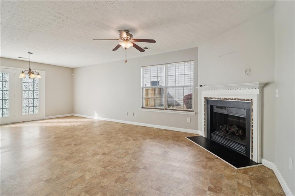 3118 Farmstead Court Grayson, GA 30017 - Photo 11 of 55 a view of empty room with fireplace and windows