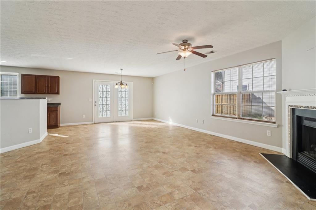 3118 Farmstead Court Grayson, GA 30017 - Photo 12 of 55 a view of an empty room with a fireplace and a window