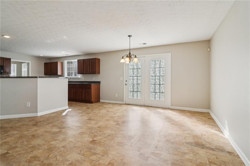 3118 Farmstead Court Grayson, GA 30017 - Photo 15 of 55 a view of livingroom with kitchen island hardwood floor and a ceiling fan