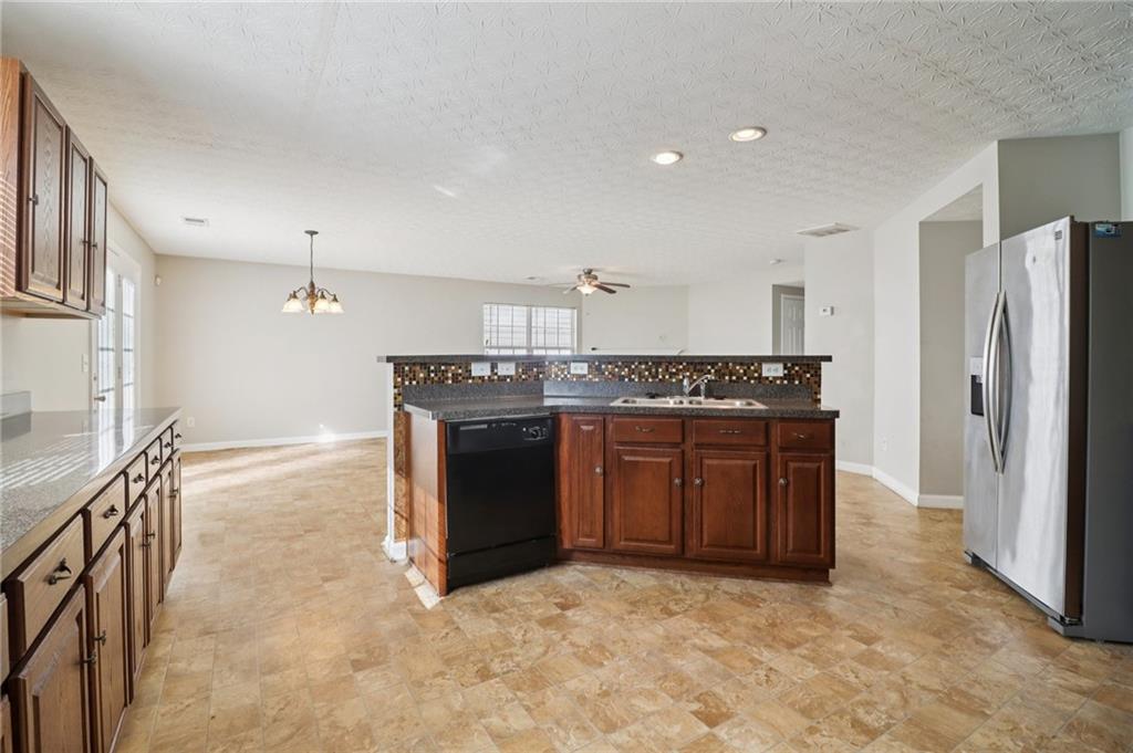 3118 Farmstead Court Grayson, GA 30017 - Photo 20 of 55 a kitchen with stainless steel appliances granite countertop a stove a sink and a refrigerator