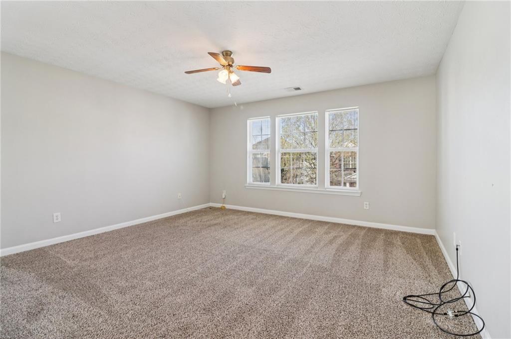 3118 Farmstead Court Grayson, GA 30017 - Photo 25 of 55 an empty room with windows and fan