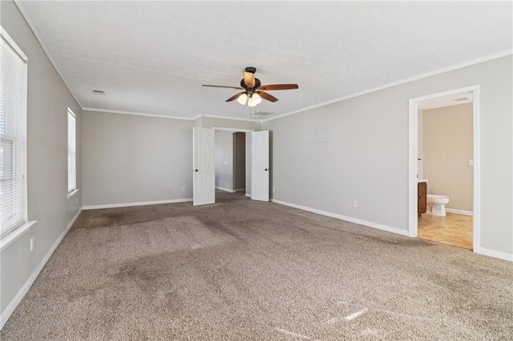 3118 Farmstead Court Grayson, GA 30017 - Photo 39 of 55 a view of a room with a ceiling fan and hardwood floor