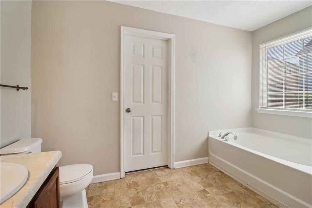 3118 Farmstead Court Grayson, GA 30017 - Photo 41 of 55 a spacious bathroom with a bathtub and toilet