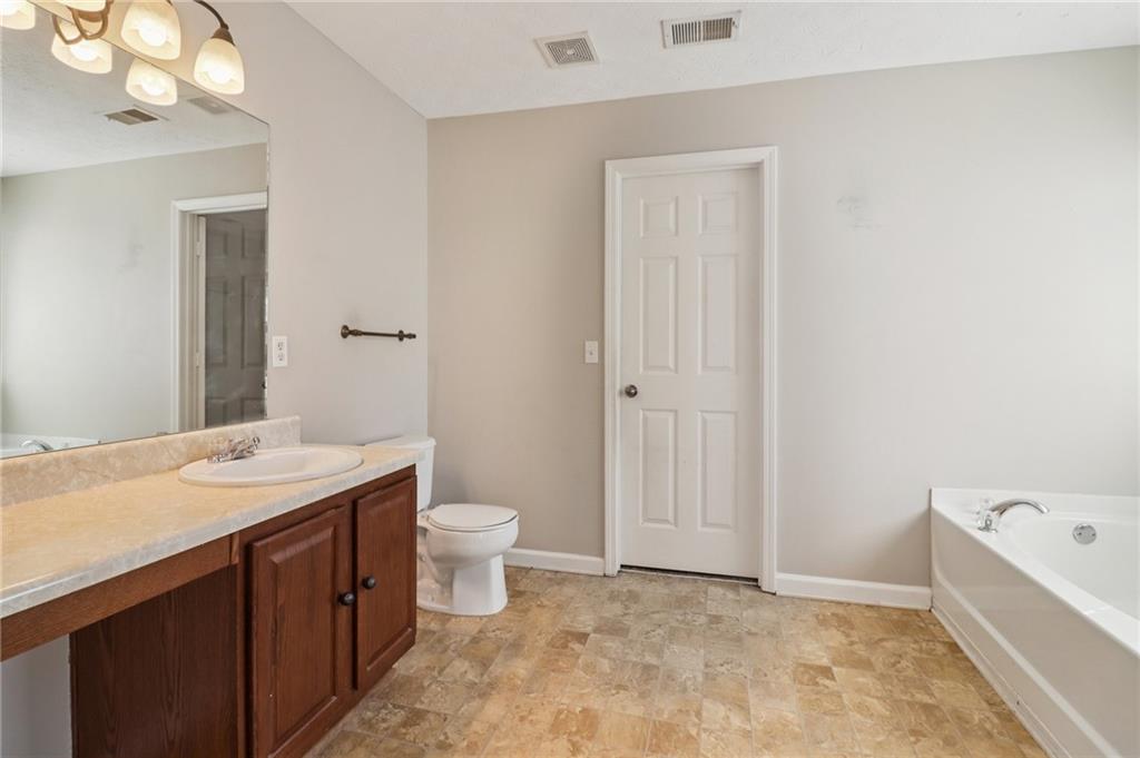 3118 Farmstead Court Grayson, GA 30017 - Photo 43 of 55 a bathroom with a sink a toilet and shower