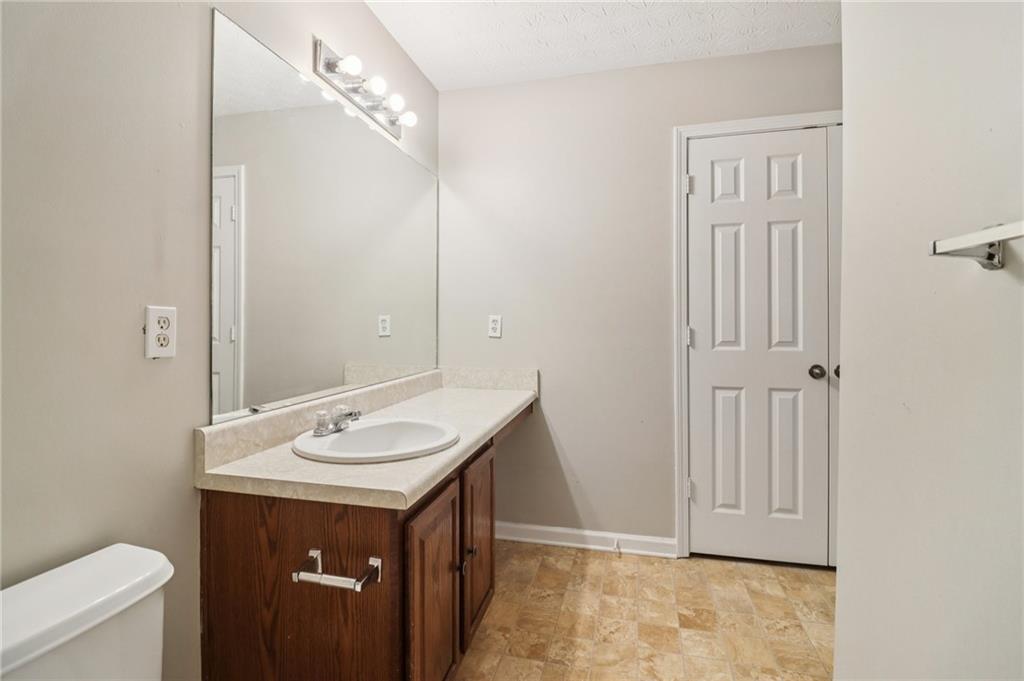 3118 Farmstead Court Grayson, GA 30017 - Photo 46 of 55 a bathroom with a sink a toilet and a mirror