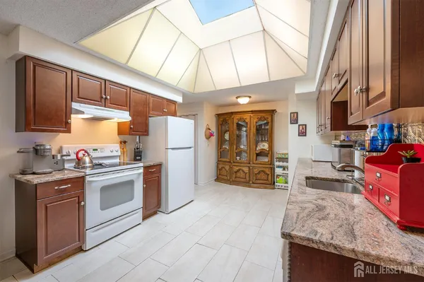 a kitchen with refrigerator and cabinets