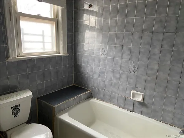 a bathroom with a toilet a sink and bathtub