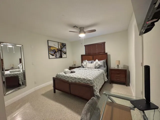 a bed room with a bed and a television