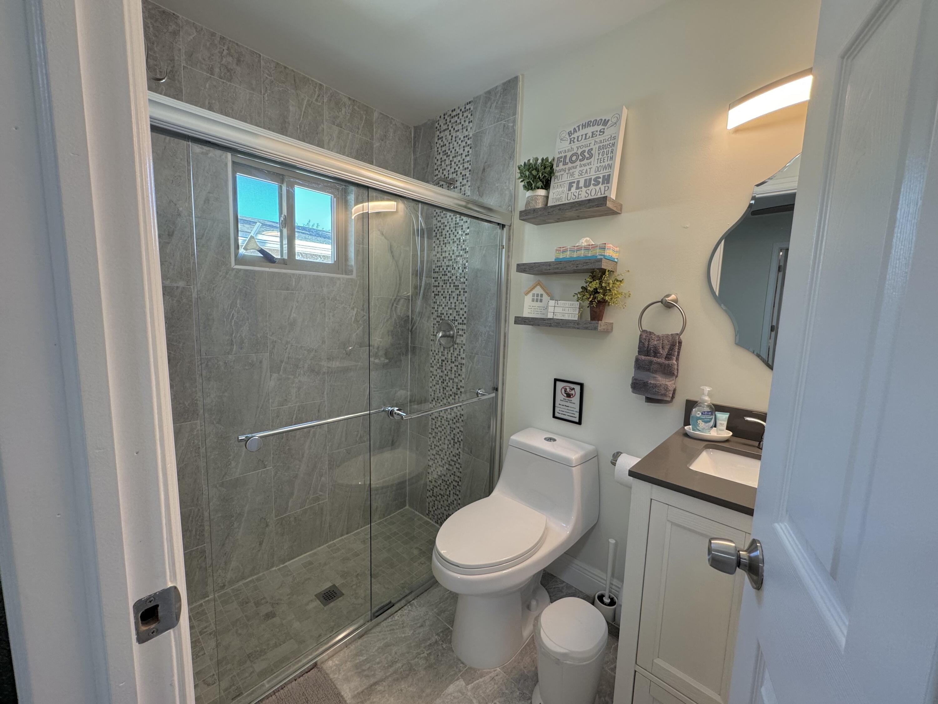 2664 Exuma Road West Palm Beach, FL 33406 - Photo 4 of 5 a bathroom with a toilet a sink and shower