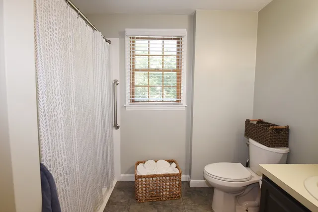 a bathroom with a toilet sink and a window