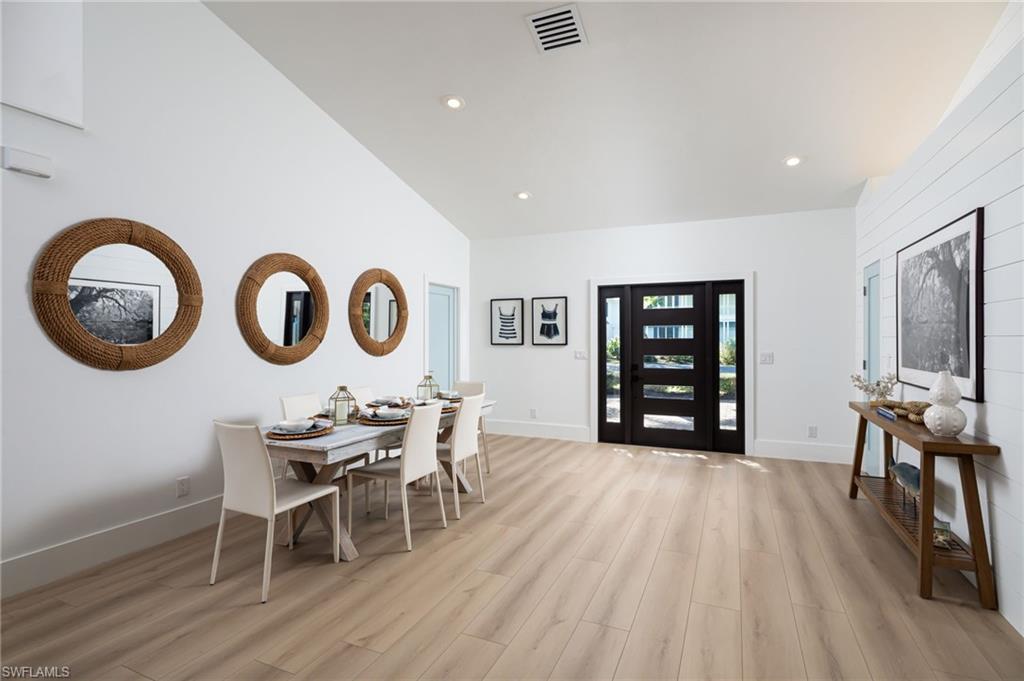 339 4th Avenue North Naples, FL 34102 - Photo 27 of 48 a view of a dining room with furniture and wooden floor