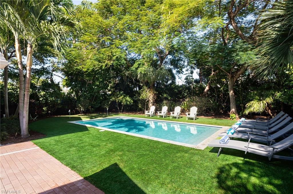 339 4th Avenue North Naples, FL 34102 - Photo 40 of 48 a view of a backyard with swimming pool