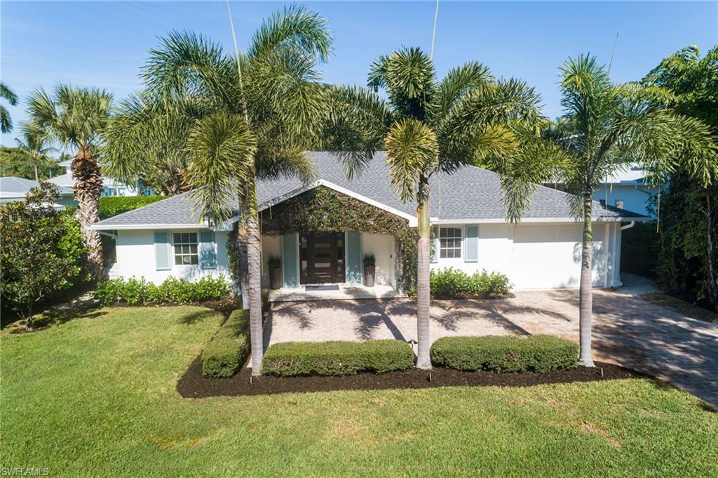 339 4th Avenue North Naples, FL 34102 - Photo 43 of 48 a front view of a house with garden