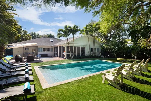 a view of a house with swimming pool and porch
