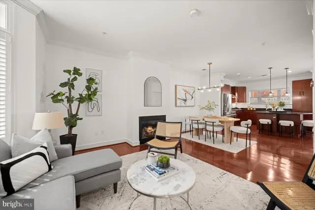a living room with furniture a rug and a flat screen tv