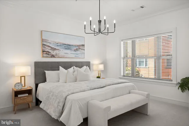 a bedroom with a bed and chandelier