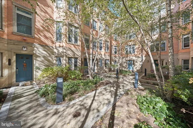 a pathway of a house with a yard