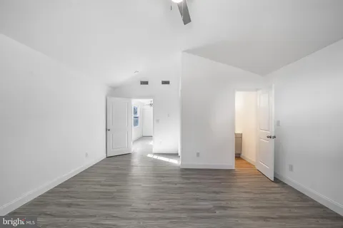 a view of a room with wooden floor and white walls
