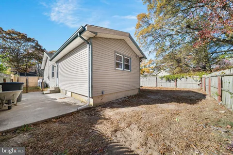 a view of backyard of house with green space