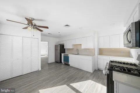a kitchen with a stove a refrigerator and a sink