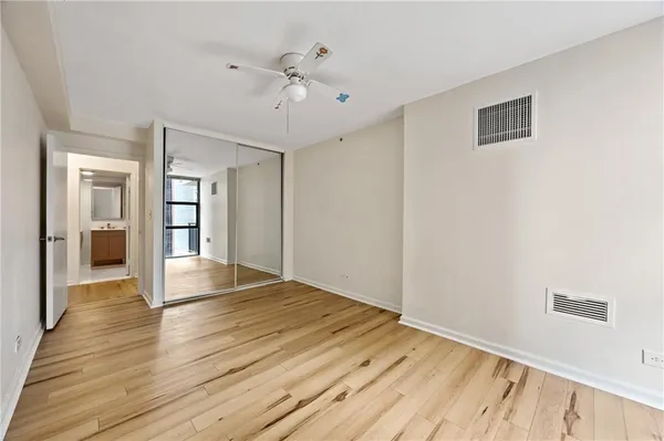a view of an empty room with wooden floor