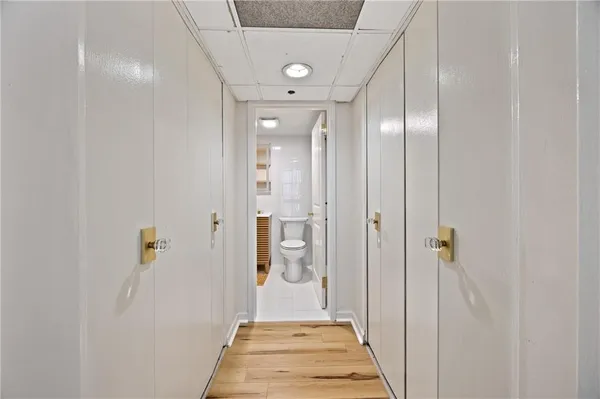 a view of a hallway with wooden shelves